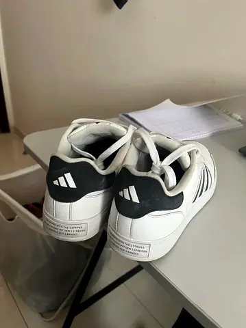 Adidas Course (or Adidas Golf Spikeless) sneakers.