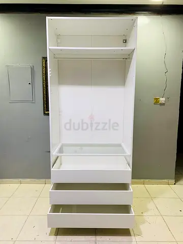 White freestanding wardrobe unit with 3 drawers and shelves