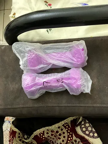 Pair of small purple neoprene dumbbells (lightweight hand weights)