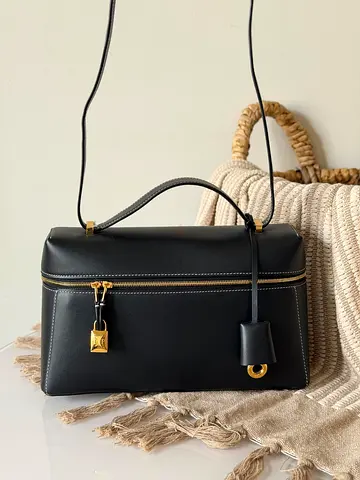 Black structured leather shoulder bag with top handle and gold hardware
