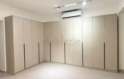 Custom built-in L-shaped wardrobes - modern beige finish
