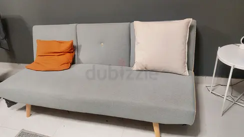 Light grey fabric sofa bed with wooden legs - good condition