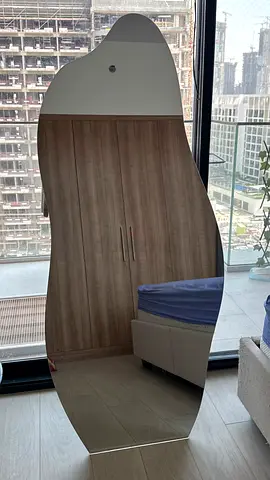 Full-length wavy-edge wall mirror — good condition
