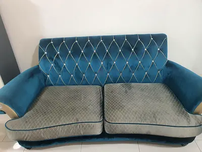 Blue velvet 2-seater sofa with button-tufted back and 2 white leather sofas