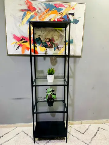 Tall black metal shelving unit with 5 glass shelves — good condition