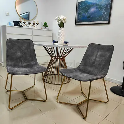 Pair of modern grey velvet dining chairs with gold legs