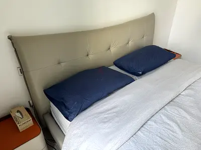 modern upholstered king sized bed with padded headboard