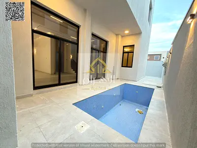Villa for sale in Al Yasmeen, Ajman. Includes electricity, air conditioning, and a swimming pool. Features 5 master bedrooms, a majlis, a living area,