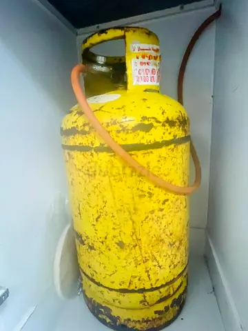 Used yellow LPG gas cylinder - functional (needs refill)
