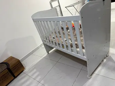 White wooden baby crib in good condition