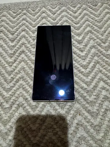 Used black smartphone with in-display fingerprint - good working condition