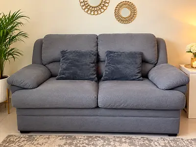 Comfortable 2-seater grey fabric sofa in good condition