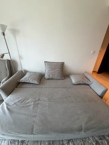 Light grey fabric sofa bed / lounge with cushions