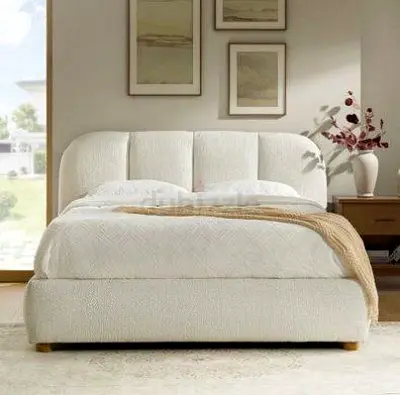 Cream upholstered queen bed with curved headboard