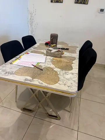Marble like top dining table with 4 upholstered chairs - good condition price is negotiable