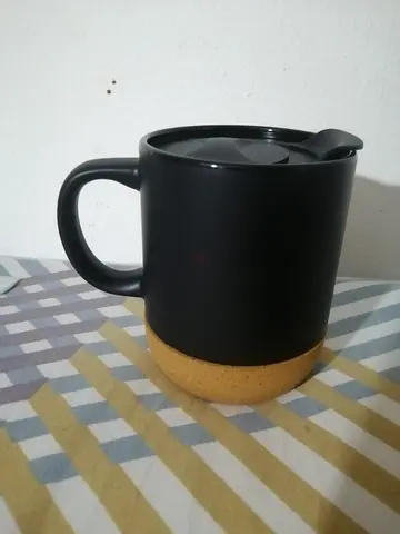 Black ceramic travel mug with spill-proof lid