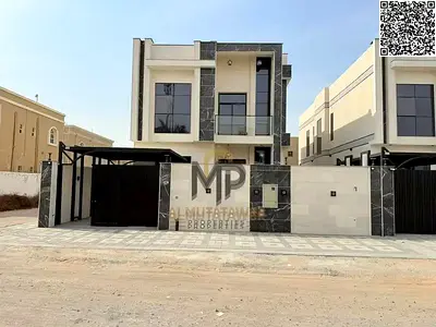 Luxury villa for sale in Al Muwaihat 3 – Ajman. Situated on a corner plot (facing a street and a side alley), this property features 5 master bedrooms