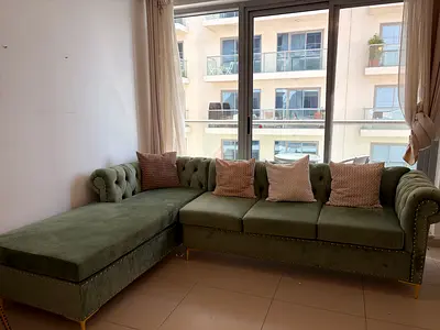 Olive Green Velvet L-Shaped Chesterfield Sofa with Chaise with a Wooden Coffee Table