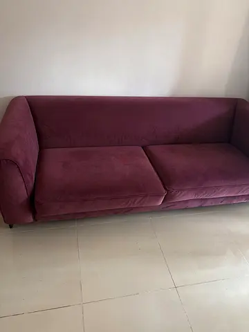 Plum three-seater fabric sofa in good condition