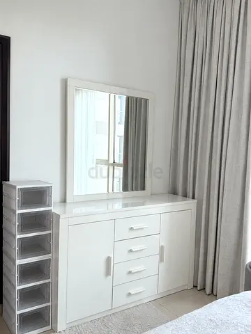 White dresser with mirror and storage drawers - good condition