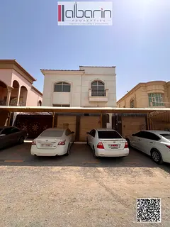 Villa for rent in Al Muwaihat, Ajman; features 5 master bedrooms, 2 living rooms, and a spacious set