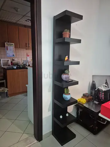 Tall black corner shelving unit — 6-tier display shelf