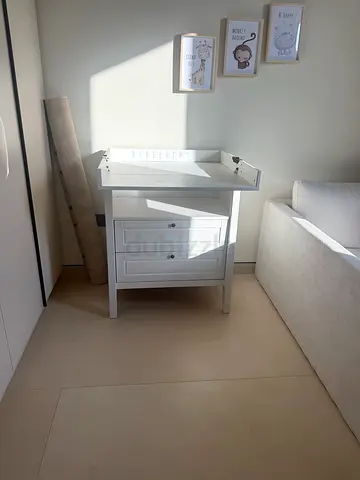 White wooden cabinet with storage doors - changing table