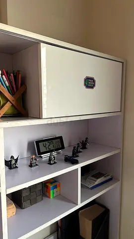 White wall-mounted storage shelves on study table with flip cabinet — good condition