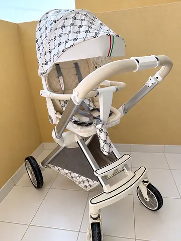 Lightweight white designer-style stroller with canopy and storage basket