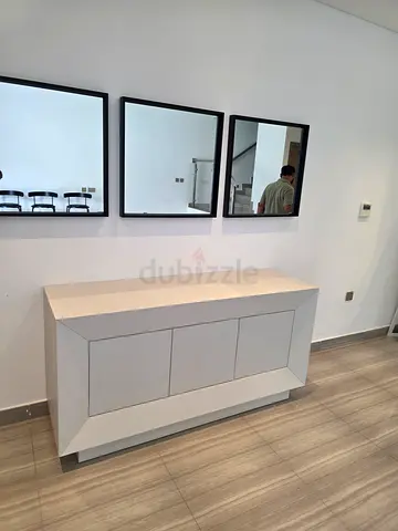 Modern wooden white console / sideboard with geometric front panels with mirror