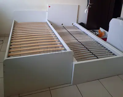 Two white single bed frames with slatted bases - good condition. Ikea beds.