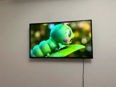 43-inch 4K UHD Smart LED TV mounted on wall - good condition