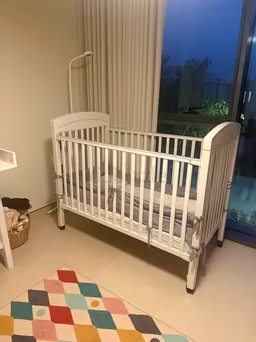 White wooden baby crib in good condition