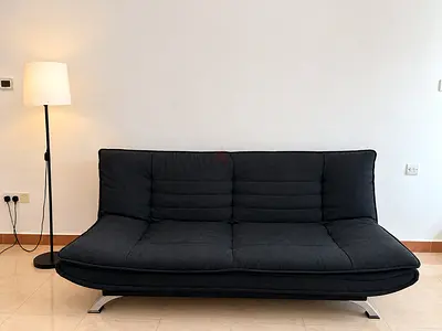 Dark grey convertible sofa bed in good condition with IKEA lamp