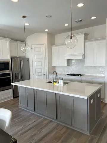 Modern kitchen island with quartz countertop and pendant lights