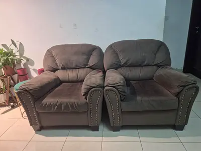Pair of comfortable brown upholstered armchairs with studs