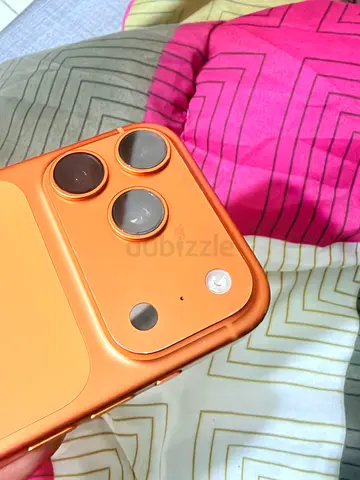 Orange iPhone in good working condition with triple camera (used)