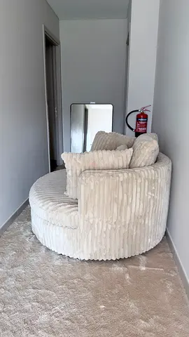 Round cream corduroy swivel lounge chair with cushions