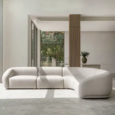 Modern curved modular sectional sofa in light beige — like new