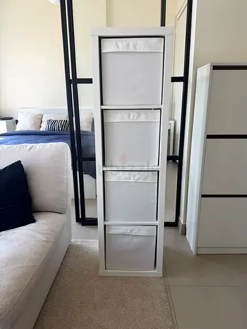 IKEA shelf unit with 4 fabric bins - good condition