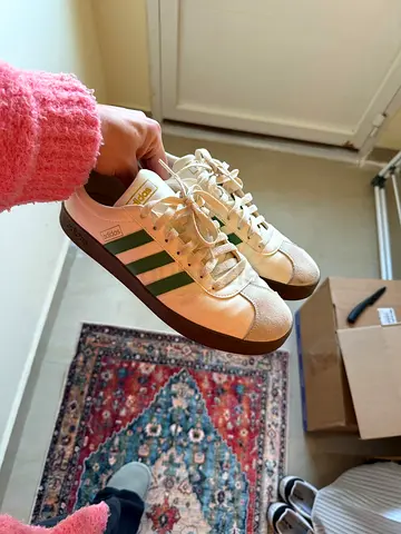 White Adidas style sneakers with green stripes, lightly used