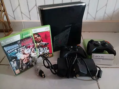 Xbox 360 along with 2 controller and 4 games including RDR and SMACK DOWN VS RAW 2011