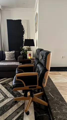Black leather executive office chair with wooden frame