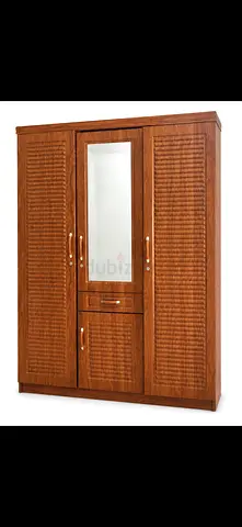 Three-door wooden wardrobe with mirror and drawer