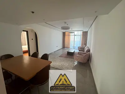 2BR in Al Nuaimiya 3, near Carrefour & Grand Mall. Balcony, central AC, free parking. AED 50K negotiable, 4 payments.