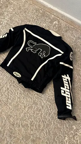 Black motorcycle riding jacket with panther logo - size L (used)