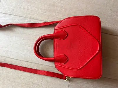 Red structured leather crossbody handbag with top handles