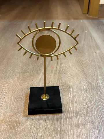 Brass Eye-Shaped Decorative Stand on Black Marble Base