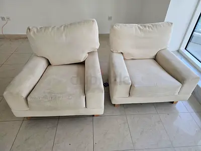 Pair of used cream fabric armchairs — very comfortable single seats