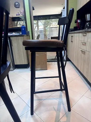 Set of 2 tall wood bar stools with brown padded seats